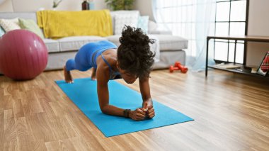 African american woman training abs exercise at home