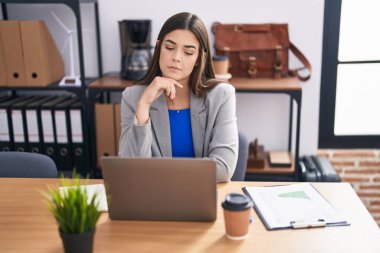 Young beautiful hispanic woman business worker using laptop working at office