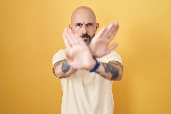 Hispanic Man Tattoos Standing Yellow Background Rejection Expression Crossing Arms — Stock Photo, Image