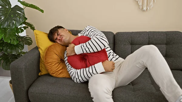 Worried Young Hispanic Man Suffers Stomachache Unhappily Lying Home Sofa — Stock Photo, Image