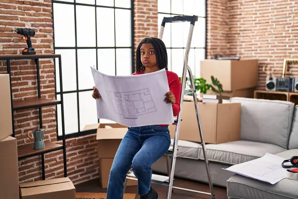 Young African American Braids Standing New Home Looking Blueprints Puffing — Stock Photo, Image