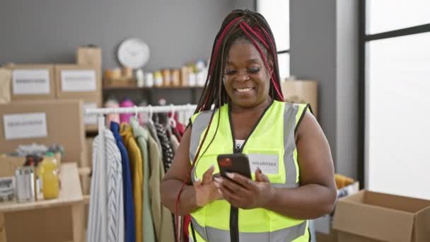 Joyful African American Volunteer Woman Texting Winning Gesture Smartphone Celebrating — Stock Video