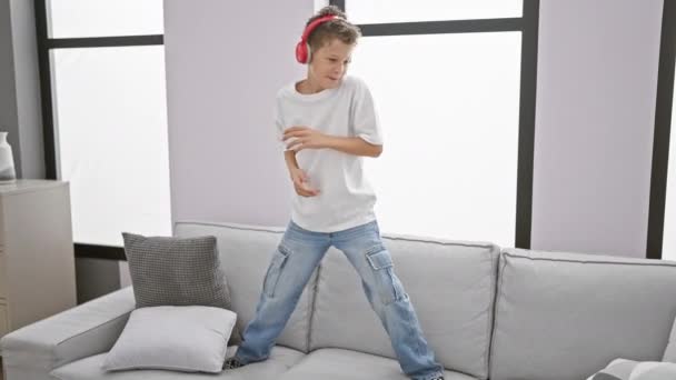 Roztomilý Blonďatý Chlapec Radostně Tančí Pohovce Sebevědomě Užívá Svou Hudbu — Stock video