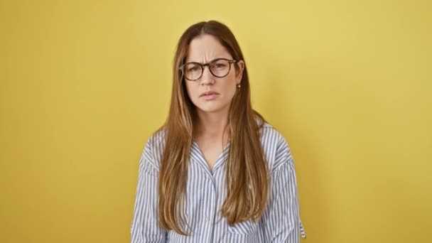 Perplexed Young Woman Blue Eyes Wearing Glasses Isolated Yellow Background — Stock Video