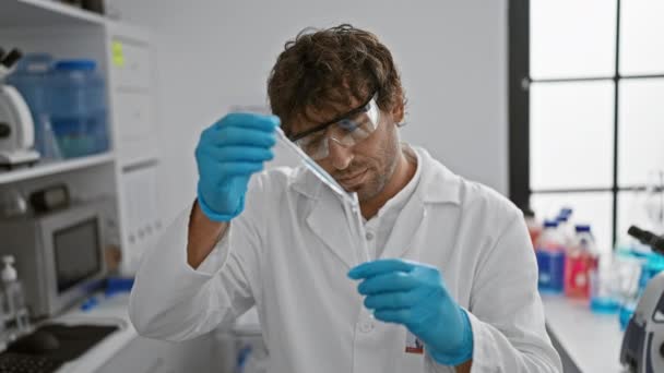 Focused Man Lab Coat Examines Test Tube Laboratory Shelves Chemicals — Stock Video