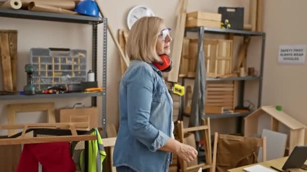 成熟した慎重な女性 安全ゴーグルを身に着けている交差した腕と木工研修会の聴覚保護 — ストック動画