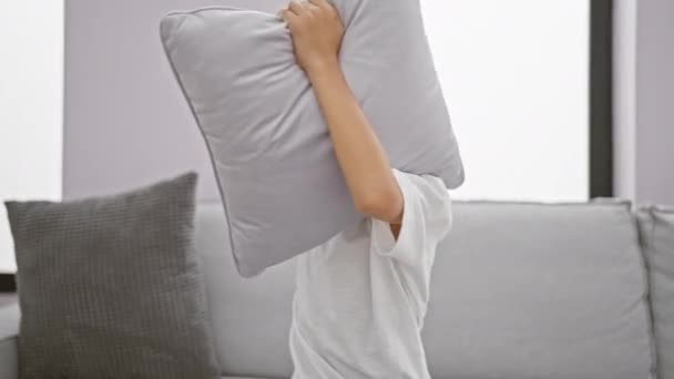 Adorable Blond Boy Sitting Sofa Home Covers Ears Cushion Screaming — Stock Video