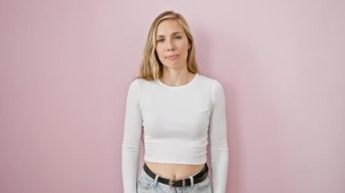 Neşeli genç sarışın kadın ellerini kaldırıyor, parmaklarıyla on numarayı gösteriyor, neşeyle işaret ediyor. Güvenli bir şekilde izole edilmiş pembe arkaplan üzerinde poz.