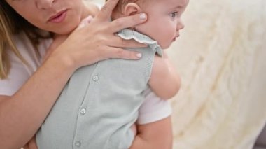 Evde, neşeli anne koltukta oturuyor, kendinden emin, sevgiyle gülüp geçen kızını uyutmaya çalışıyor, gülümseme dolu ilişkilerini geliştiriyor..