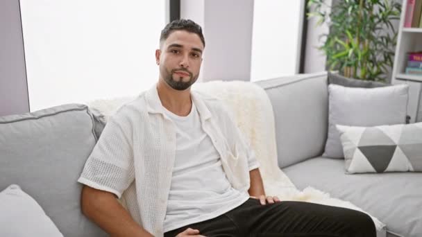 Cheerful Young Arab Man Sofa Smiling Brightly Offering Friendly Welcoming — Stock Video