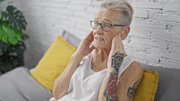 Gestresste Grauhaarige Seniorin Die Unter Kopfschmerzen Leidet Sitzt Auf Dem — Stockvideo
