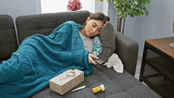 Young Woman Rests Couch Blue Blanket Holding Remote Surrounded Tissues — Stock Photo, Image
