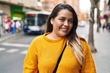 Young beautiful plus size woman smiling confident standing at street