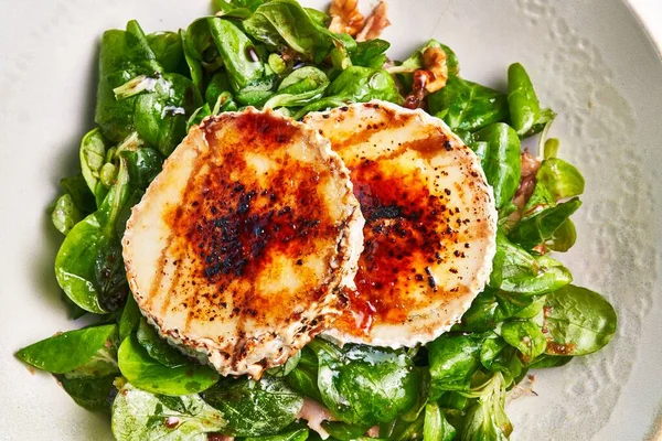 Gourmet Dish Featuring Caramelized Goat Cheese Atop Fresh Spinach Salad — Stock Photo, Image