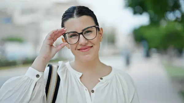 年轻美丽的惊慌失措的女人微笑着 自信地站在街上举着眼镜 — 图库照片