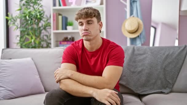 Portrait Serious Young Hispanic Man Sitting Sofa Contemplating Problem Indoors — Stock Video