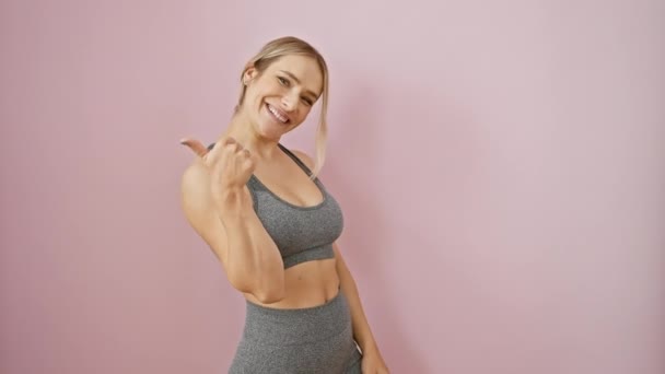 Joyful Young Blonde Woman Beaming Positivity Pointing Thumb Sportswear Isolated — Stock Video