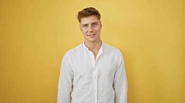 Laughing, confident young caucasian man in casual fashion, standing isolated against a yellow background, radiating positive vibes and joy clipart