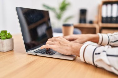 Young hispanic man business worker using laptop working at office