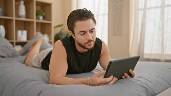 Young Hispanic Man Using Touchpad Lying Bed Bedroom — Photo