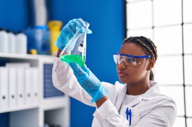African american woman scientist holding test tube at laboratory