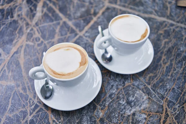 Two Cappuccinos Frothy Cream Marbled Table Symbolizing Casual Meeting Coffee — Stock Photo, Image