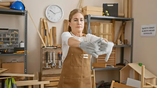 Mature Woman Apron Stretching Gloves Woodworking Studio Indicates Safety Skill — Stock Photo, Image