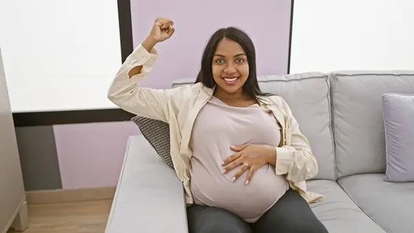 Young Pregnant Woman Touching Belly Doing Strong Gesture Arm Smiling — Stock Photo, Image