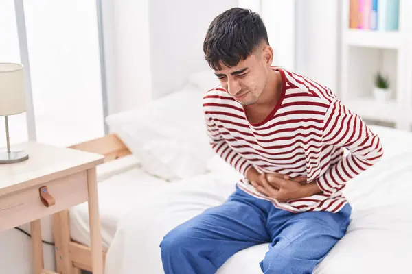 Young Hispanic Man Suffering Stomach Ache Sitting Bed Bedroom — Stock Photo, Image