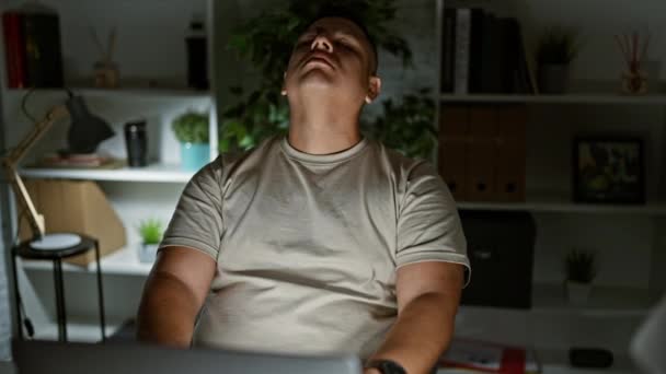 一个疲惫不堪的年轻拉丁男人在办公桌前工作到很晚 工作负担过重 他的肖像被他的高要求的工作压得喘不过气来 — 图库视频影像
