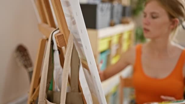 Focused Woman Artist Painting Canvas Bright Studio Interior — Stock Video
