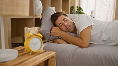 Genç İspanyol adam yatakta uzanıp yatak odasında uyuyor.