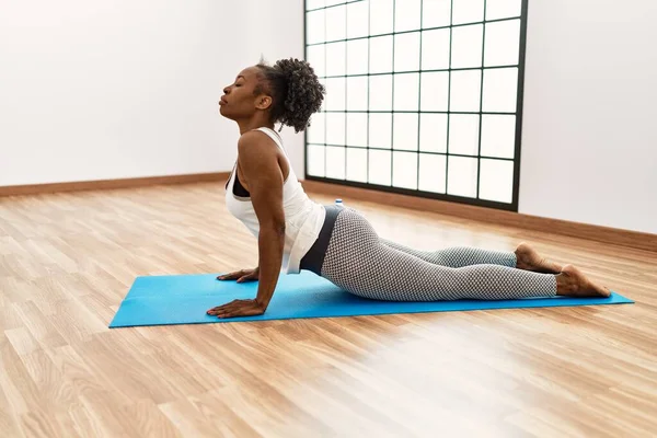 African american woman stretching back at sport center