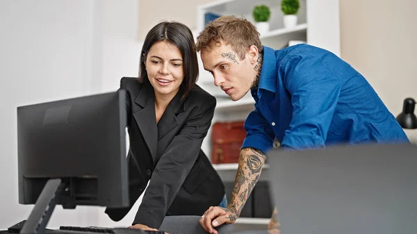 Two business workers using computer working at the office