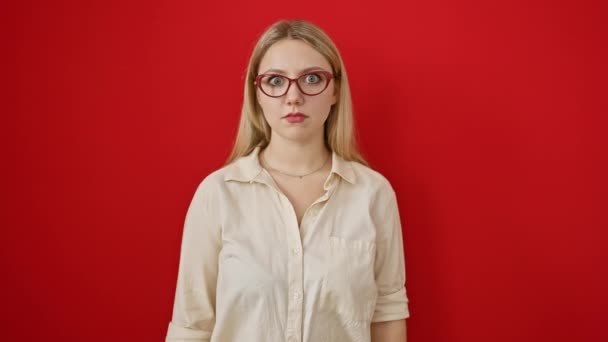 Young Blonde Woman Skeptical Sarcastic Standing Disbelief Red Isolated Background — Stock Video