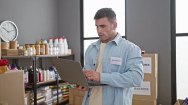 Genç, kendine güveni tam bir İspanyol gönüllü, yardım merkezinde dizüstü bilgisayar kullanıyor, birlik yaratıyor ve yardım elini uzatıyor..