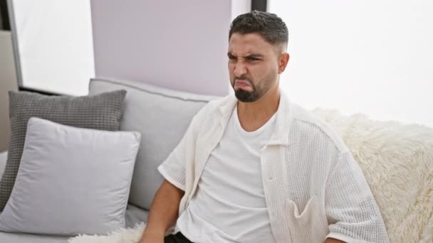 Young Arab Man Home Sitting Sofa Disgusted Expression Fearful Displeased — Stock Video