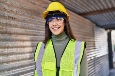 Young beautiful hispanic woman architect smiling confident standing at street