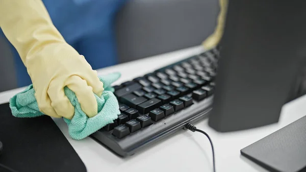 Young blonde woman professional cleaner cleaning computer keyboard at the office