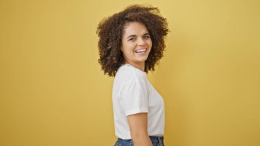 Young beautiful hispanic woman smiling confident standing over isolated yellow background