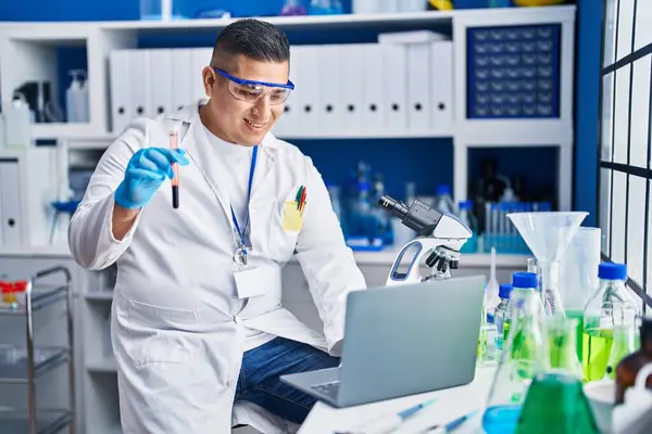 Young Latin Man Scientist Using Laptop Holding Blood Test Tube — Stock Photo, Image