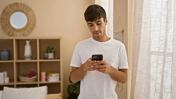 Young Hispanic Man Using Smartphone Home — ストック写真