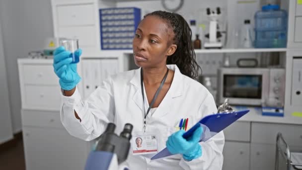 Focused Woman Scientist Examines Beaker Laboratory Setting Showcasing Research Healthcare — Stock Video