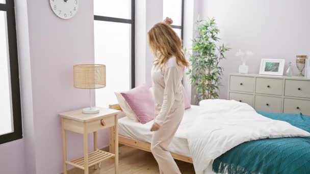Young Woman Stretching Joyfully Cozy Well Lit Bedroom Stylish Interior — Stock Video