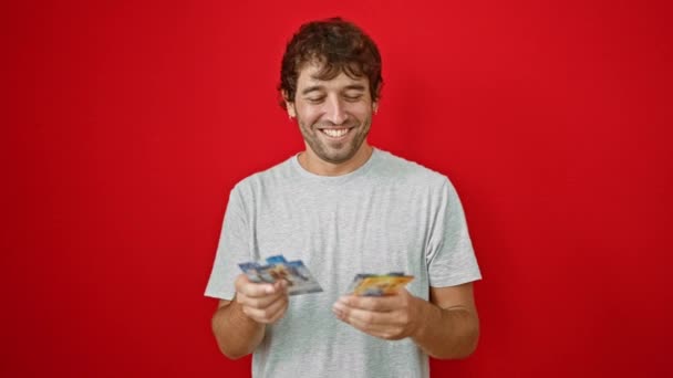 Young Man Counting Swiss Francs Banknotes Smiling Isolated Red Background — Stock Video