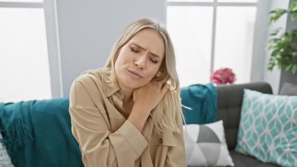Worried Unhappy Young Blonde Woman Suffers Severe Cervical Pain Sitting — Stock Video