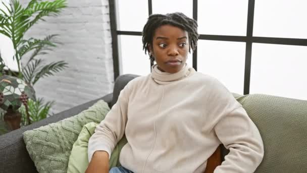 Young Black Woman Dreadlocks Sitting Sofa Home Hand Head Despair — Stock Video