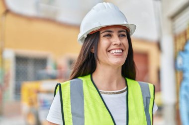 Young beautiful hispanic woman architect smiling confident standing at street