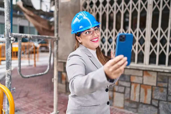 Young beautiful hispanic woman architect smiling confident having video call at street