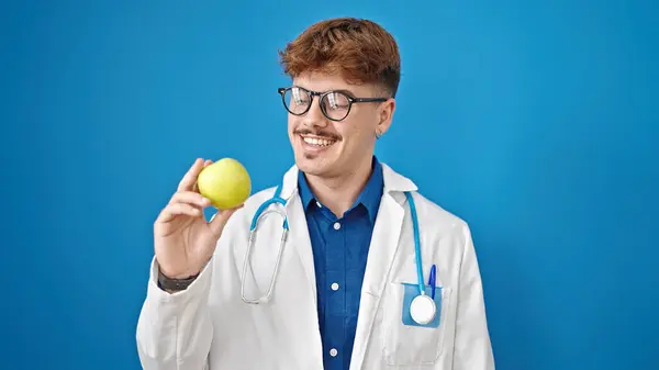 Young Hispanic Man Doctor Smiling Confident Holding Green Apple Isolated — Stock Photo, Image